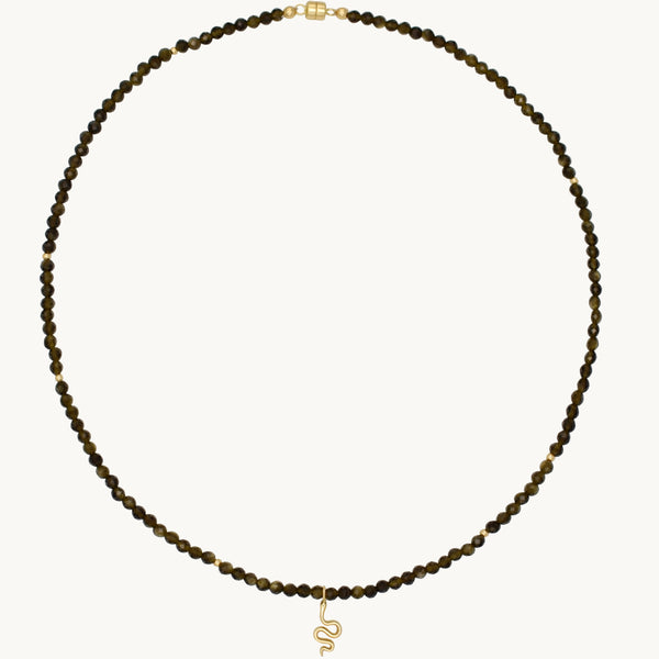 Zoya Snake Charm Necklace on golden obsidian